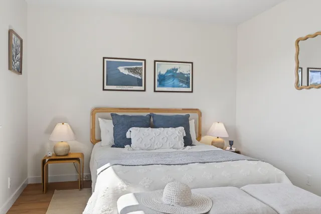 a bedroom with a bed and a lamp