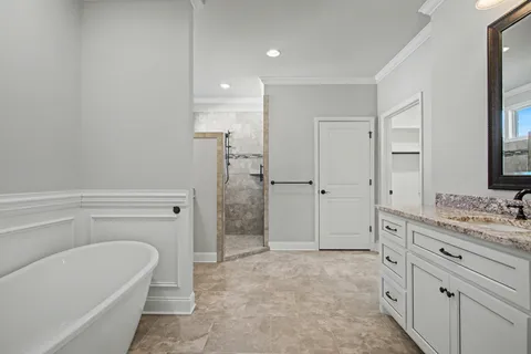 a bathroom with a granite countertop sink a toilet and shower