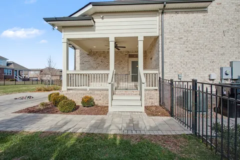 a view of a house with backyard and porch