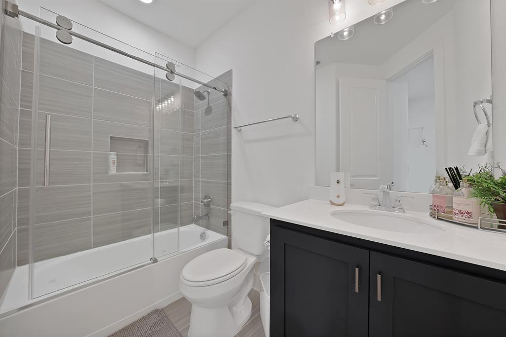 1010 Adair Road Prosper, TX 75078 - Photo 18 of 39 a bathroom with a sink a toilet and shower