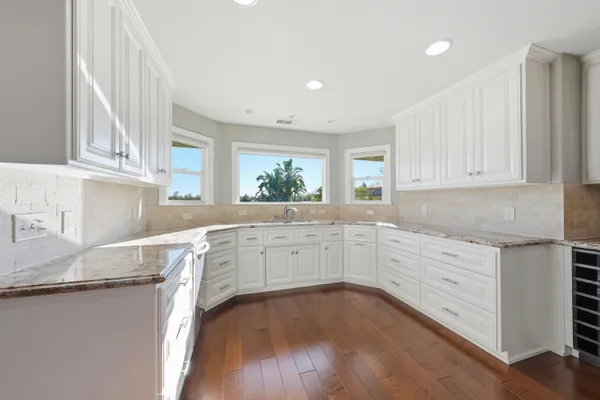 a bathroom with a granite countertop sink a toilet and shower