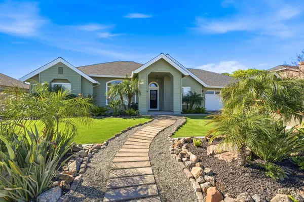 a front view of a house with garden