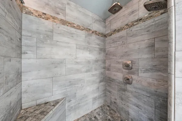 a spacious bathroom with a double vanity sink and mirror