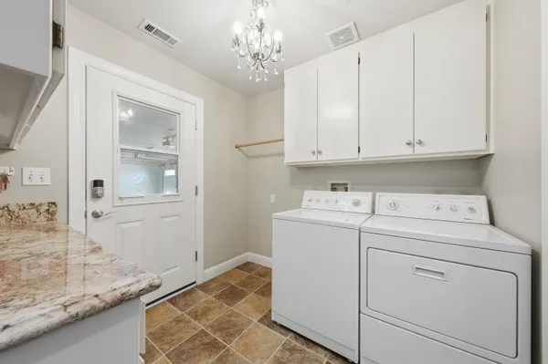 a front view of a house with swimming pool table and chairs