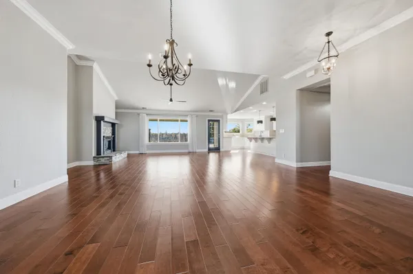 a view of a livingroom with a furniture wooden floor a chandelier