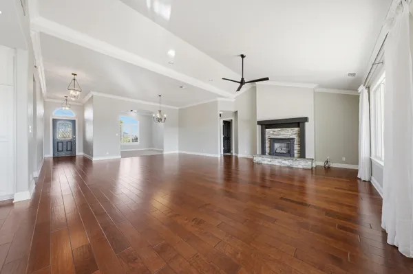 a view of empty room with wooden floor and fireplace