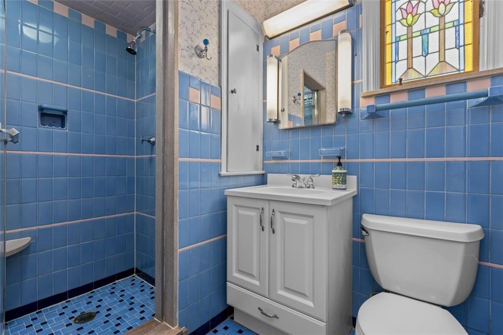 2727 Mt Royal Road Pittsburgh, PA 15217 - Photo 23 of 33 This bathroom has a step in shower and a beautiful stained glass window,