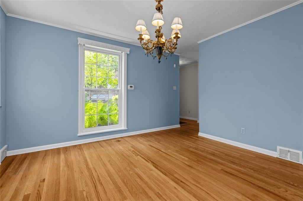 The diningroom also includes a floor-to-ceiling window for a daylit view.