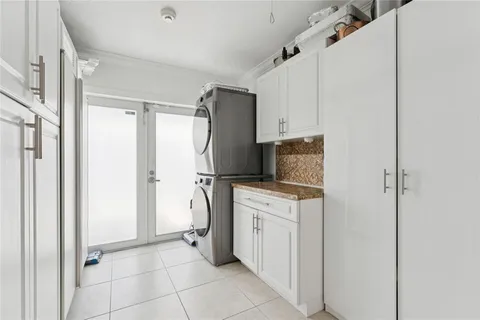 a kitchen with a refrigerator sink and cabinets