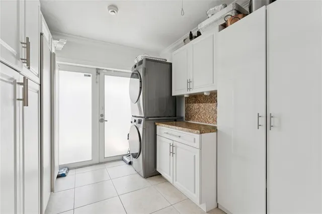a kitchen with a refrigerator sink and cabinets