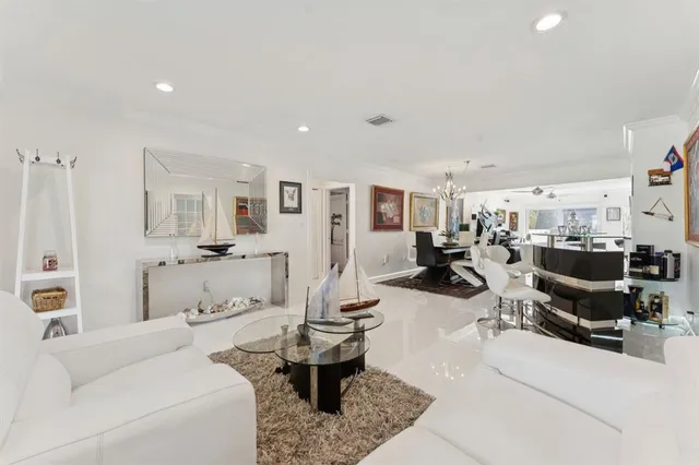 a living room with furniture and view of kitchen