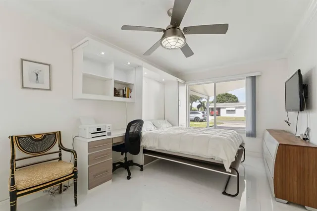 a bedroom with furniture and a window
