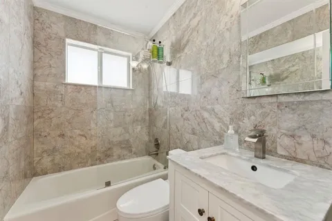 a bathroom with a sink a toilet and bathtub