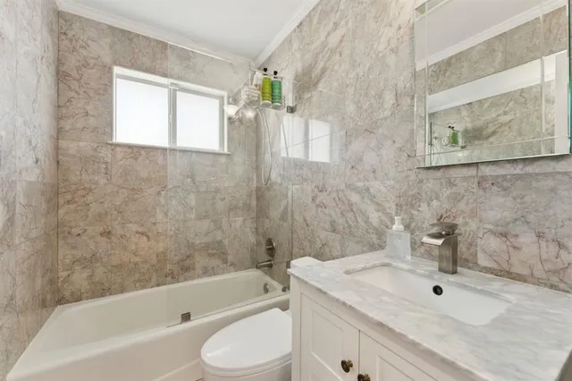 a bathroom with a sink a toilet and bathtub