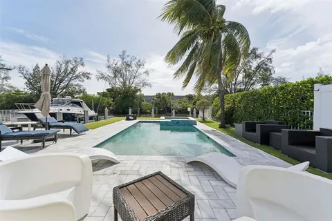 a view of outdoor kitchen with swimming pool and sitting area