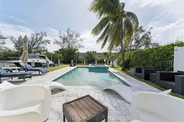 a view of outdoor kitchen with swimming pool and sitting area