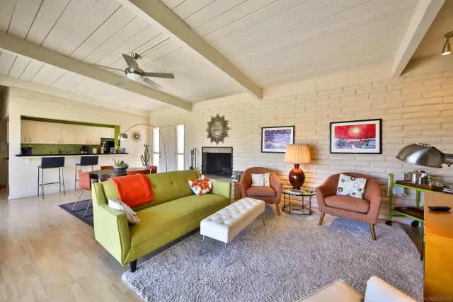 a living room with furniture kitchen view and a fireplace