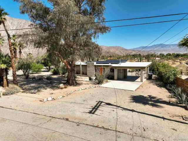 a view of a terrace with a bench and trees around