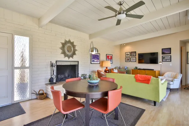 a outdoor living room with fireplace furniture and a wooden floor