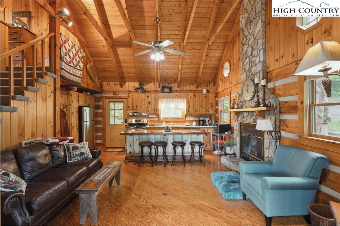 710 River Hills Road Lansing, NC 28643 - Photo 11 of 38 a living room with fireplace furniture and a chandelier