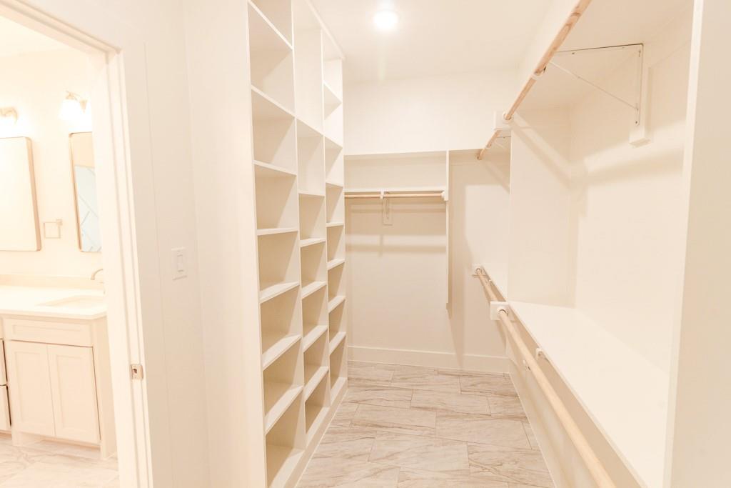 540 Highview Court Godley, TX 76044 - Photo 12 of 23 a view of walk in closet with empty racks