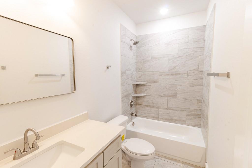 540 Highview Court Godley, TX 76044 - Photo 16 of 23 a bathroom with a granite countertop bathtub shower sink vanity and toilet