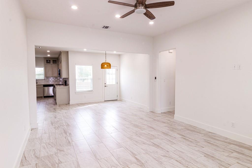 540 Highview Court Godley, TX 76044 - Photo 2 of 23 wooden floor in an empty room with a window