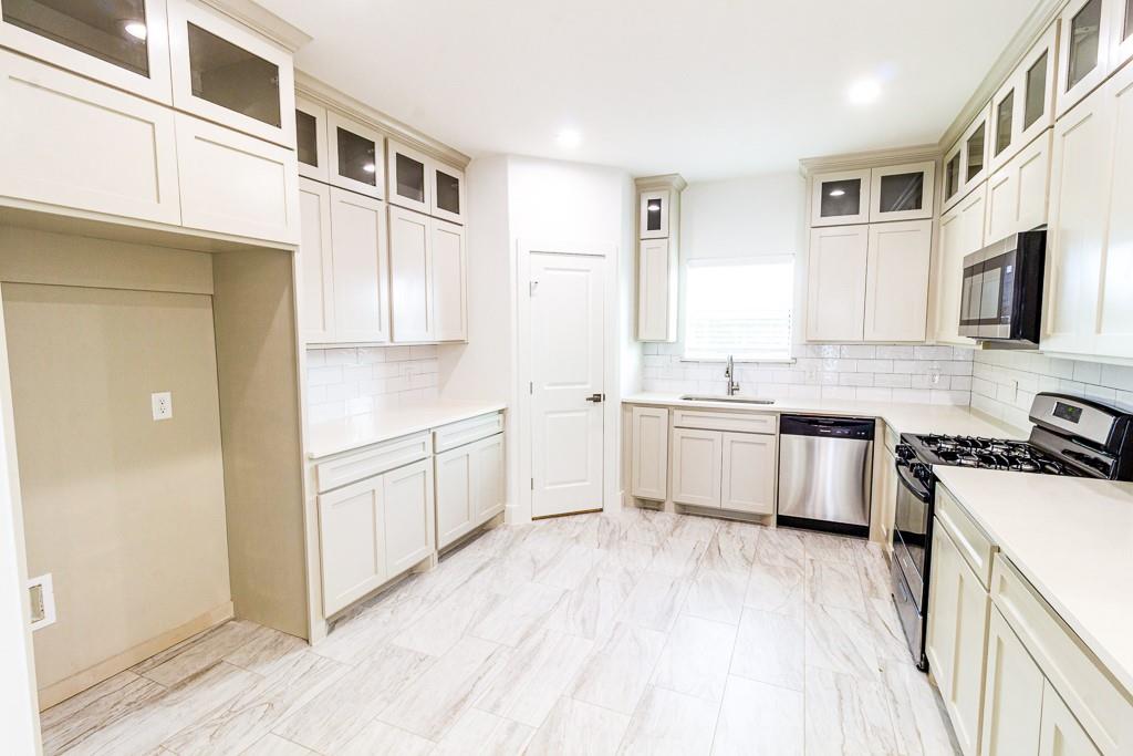 540 Highview Court Godley, TX 76044 - Photo 6 of 23 a kitchen with granite countertop white cabinets and white appliances