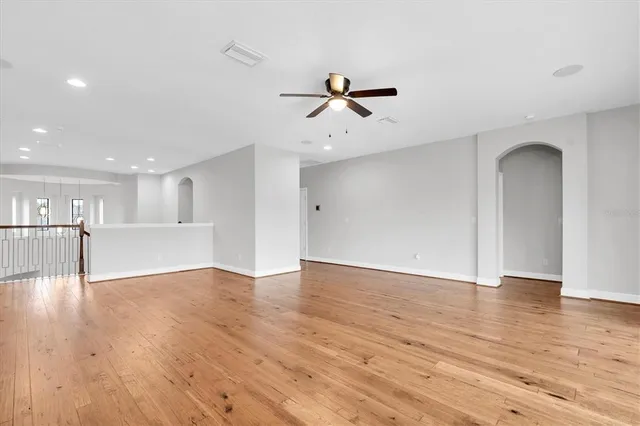 a bathroom with a granite countertop sink a mirror and shower