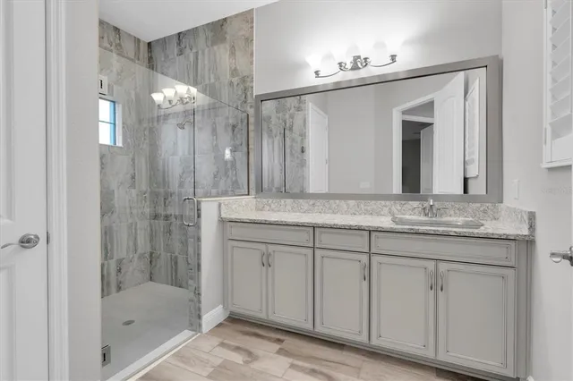 a view of a lake with a yard and a large tree