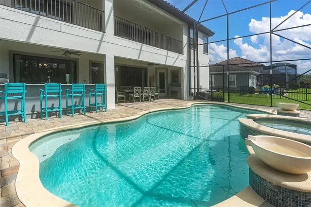 an aerial view of a house with a garden and lake view