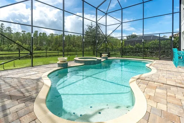 a kitchen with stainless steel appliances kitchen island granite countertop a table chairs and a refrigerator