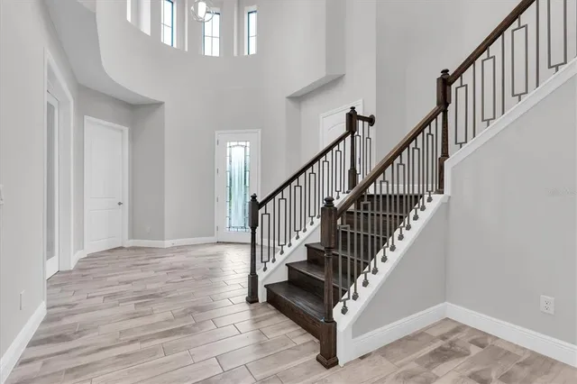 a kitchen with white cabinets and appliances