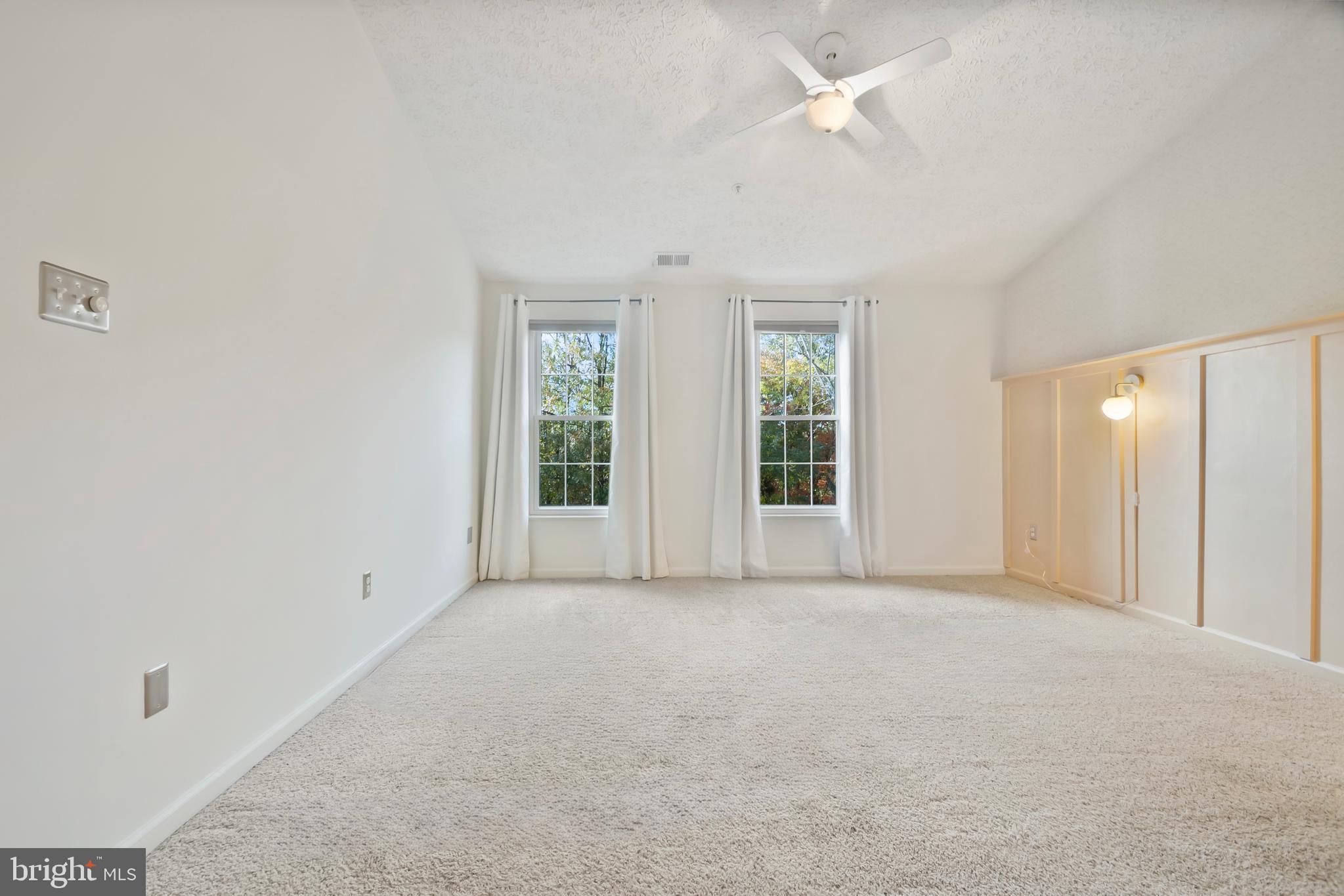 8265 Poplar Mill Road, Unit 8265 Nottingham, MD 21236 - Photo 16 of 35 an empty room with windows and fan