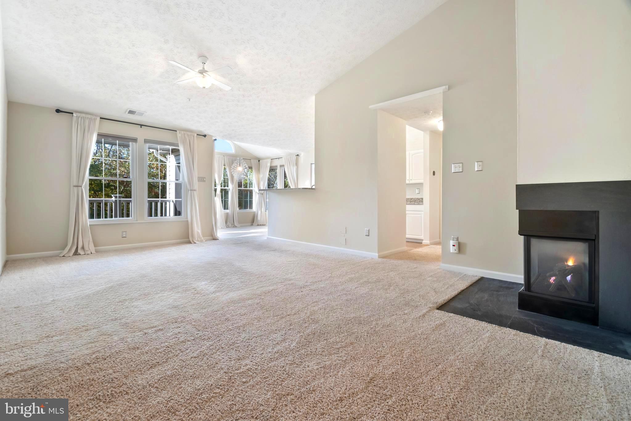 8265 Poplar Mill Road, Unit 8265 Nottingham, MD 21236 - Photo 2 of 35 a view of a livingroom with wooden floor and a fireplace
