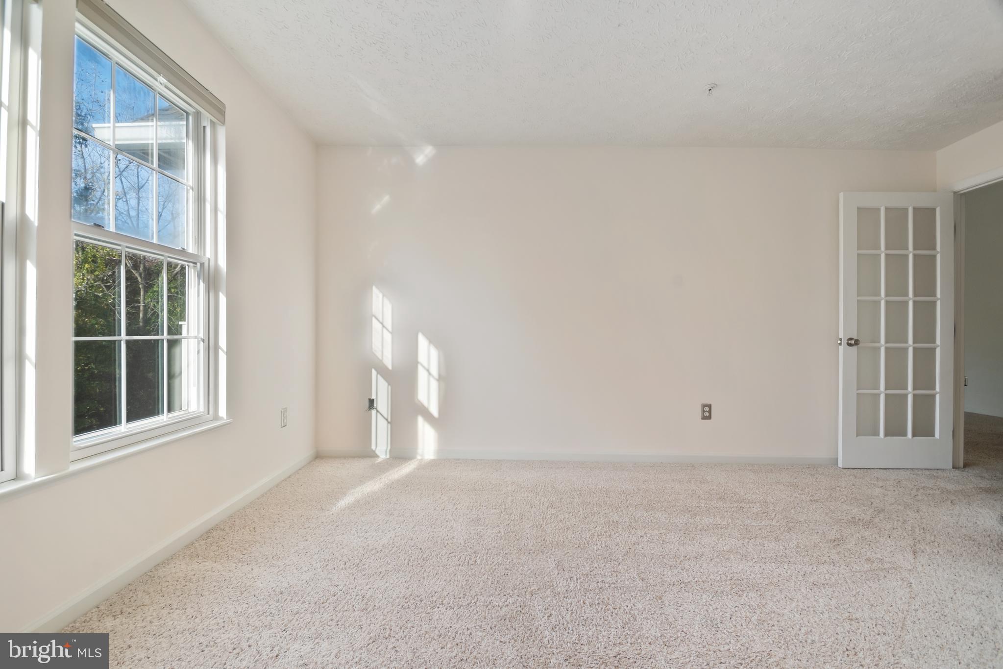 8265 Poplar Mill Road, Unit 8265 Nottingham, MD 21236 - Photo 23 of 35 a view of an empty room with a window