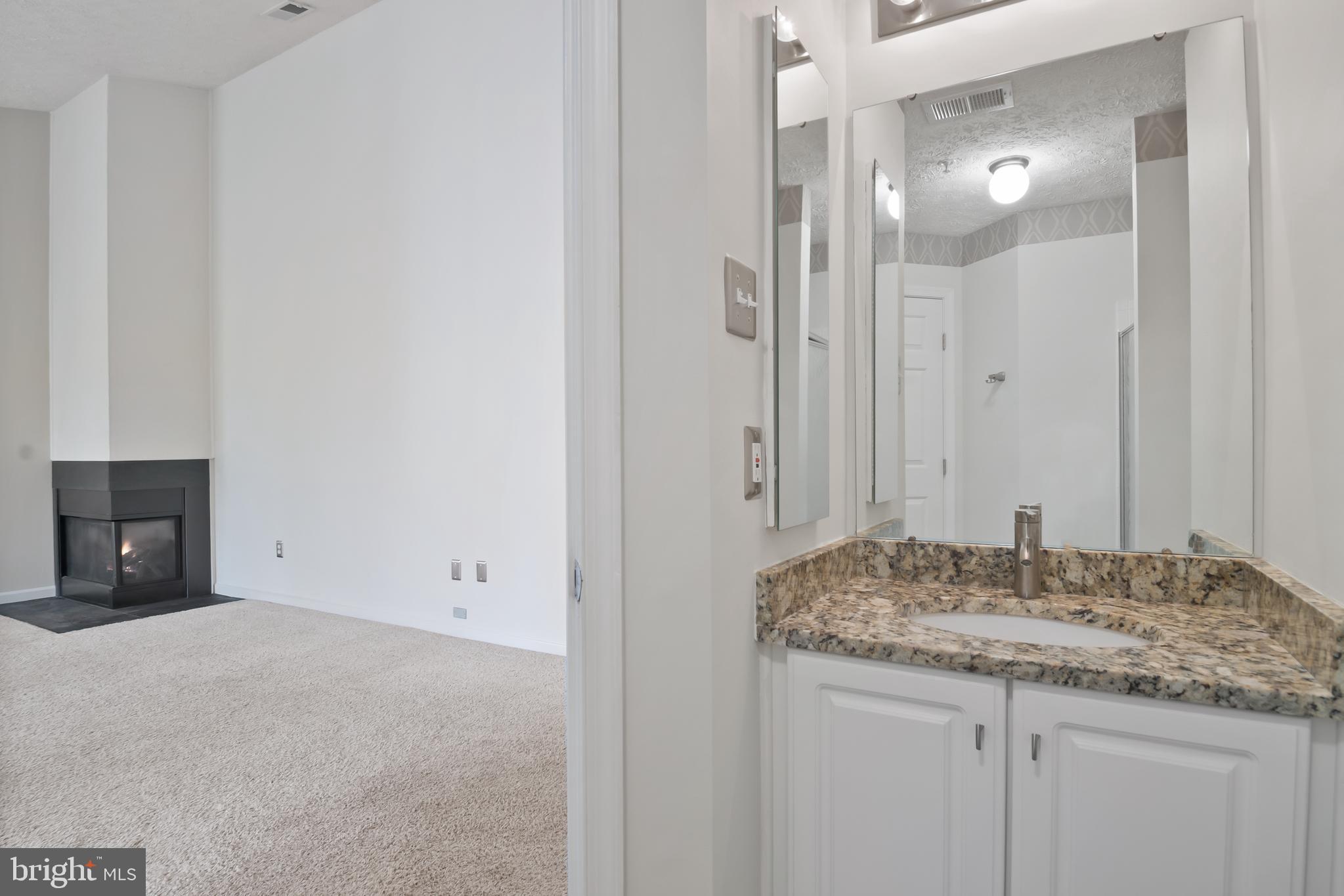 8265 Poplar Mill Road, Unit 8265 Nottingham, MD 21236 - Photo 25 of 35 a bathroom with a granite countertop sink and a mirror