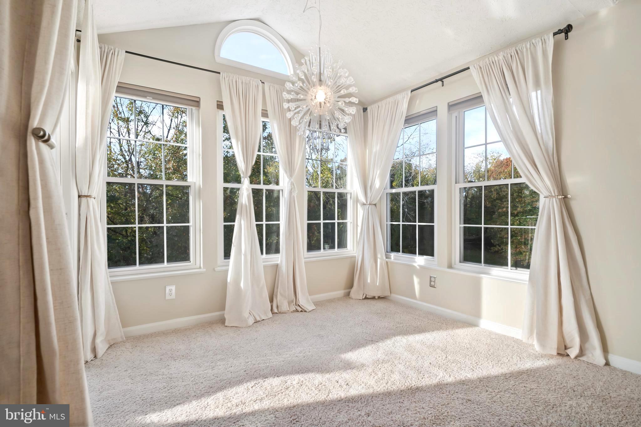 8265 Poplar Mill Road, Unit 8265 Nottingham, MD 21236 - Photo 5 of 35 a front view of a house with large windows