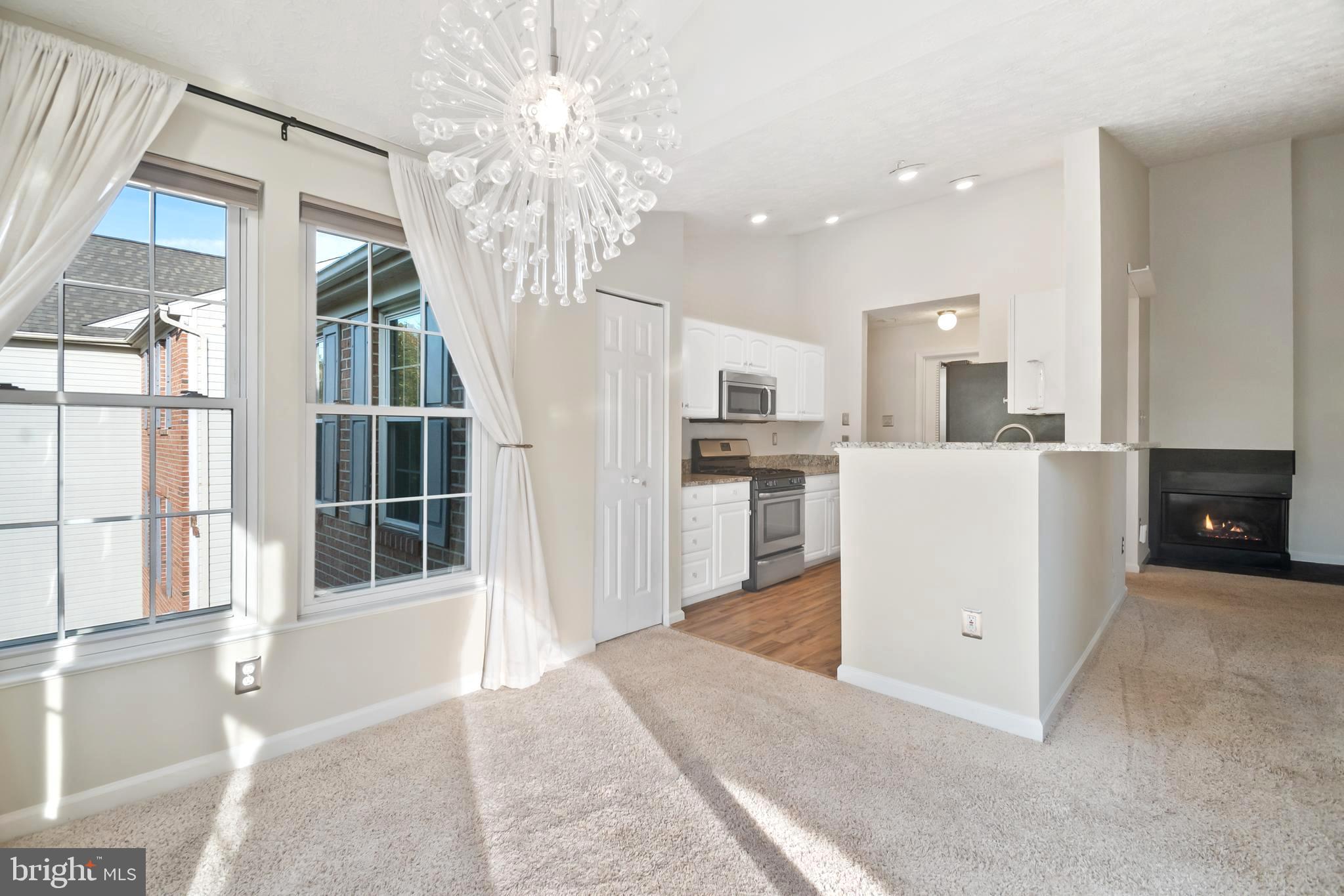 8265 Poplar Mill Road, Unit 8265 Nottingham, MD 21236 - Photo 9 of 35 a view of a kitchen with fridge and wooden floor