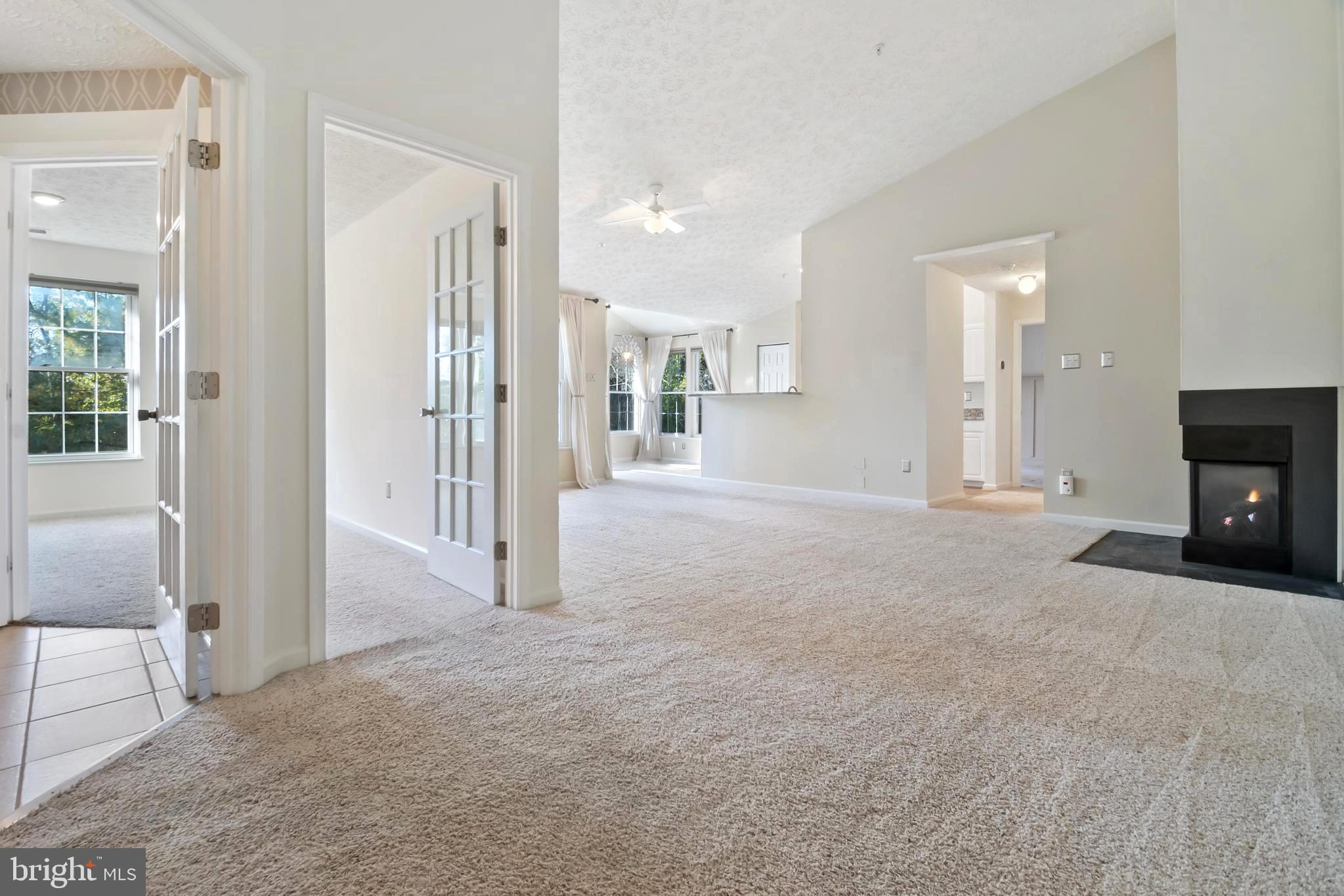 8265 Poplar Mill Road, Unit 8265 Nottingham, MD 21236 - Photo 10 of 35 a view of a livingroom with a fireplace and a window