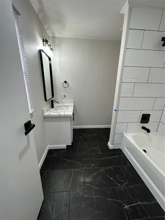 a bathroom with a sink toilet and tub