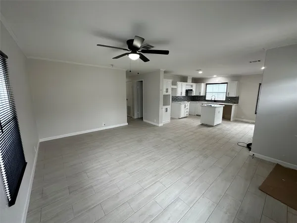 a view of a kitchen with a sink and wooden floor