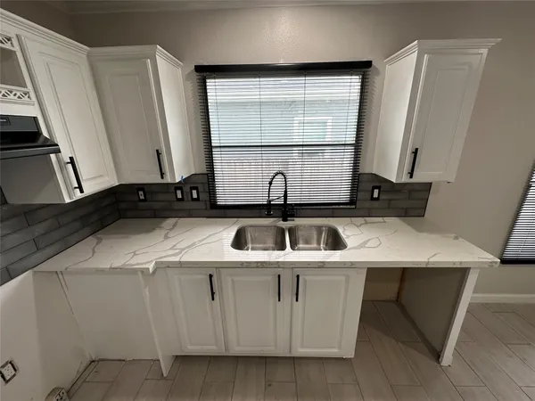 a kitchen with a sink and a washing machine