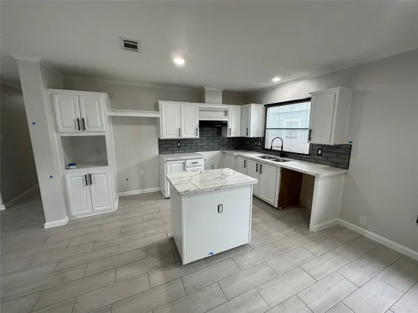 a kitchen with stainless steel appliances granite countertop a stove top oven a sink a counter top space and cabinets