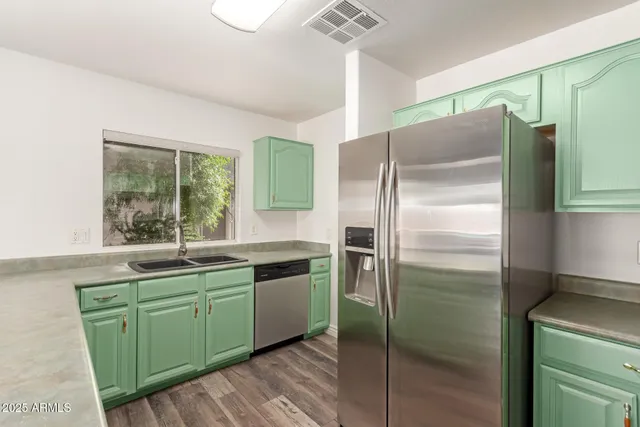 a kitchen with a refrigerator and a sink