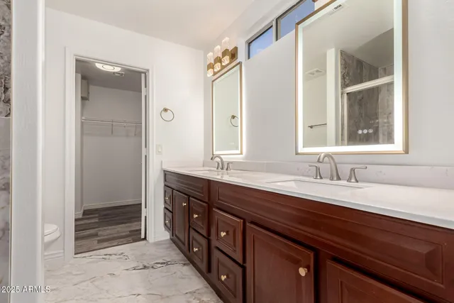 a bathroom with a granite countertop sink mirror and double