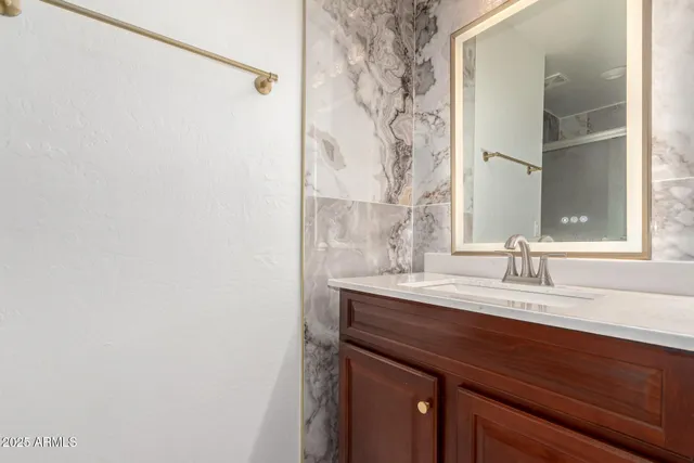 a bathroom with a sink and a mirror
