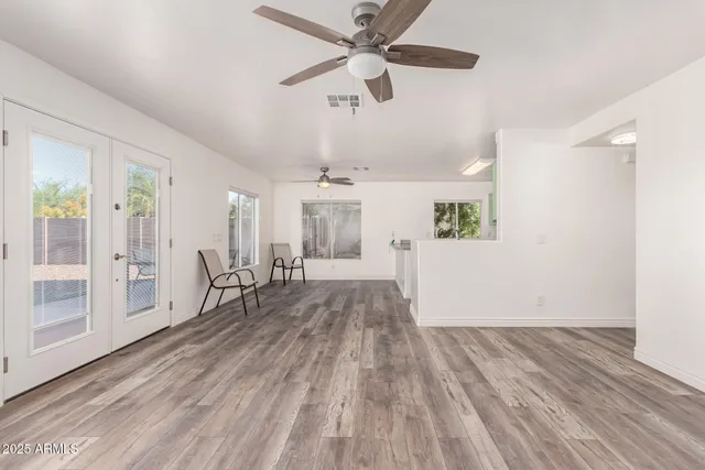 wooden floor in an empty room with a window