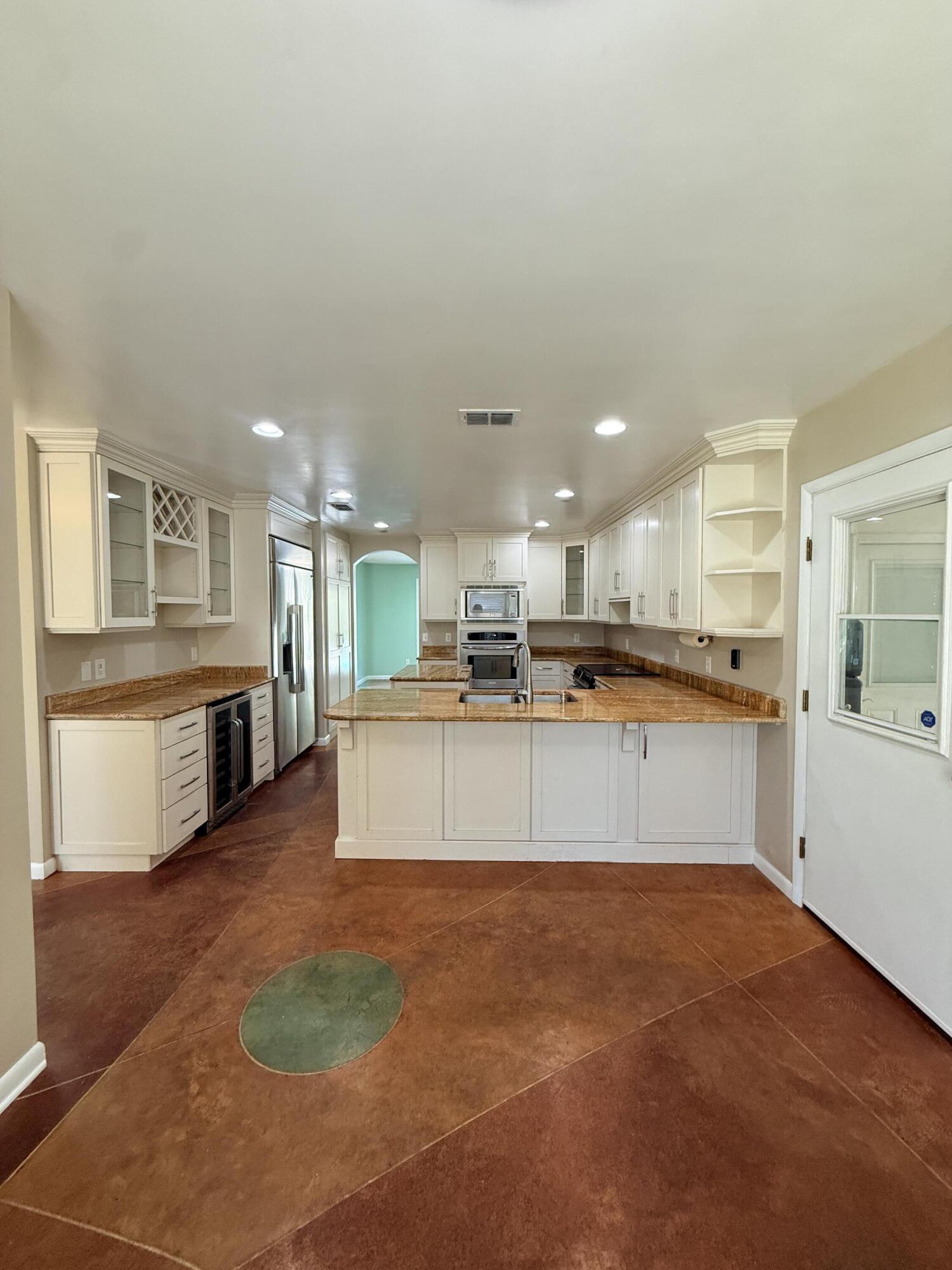 255 Ridge Lake Road Crestview, FL 32536 - Photo 13 of 39 a large kitchen with stainless steel appliances kitchen island a large counter top a stove and a sink