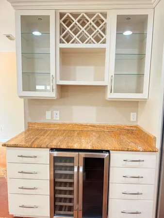 a view of a room with a ceiling fan and window